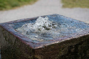 Picture of old stone well with water bubbling up